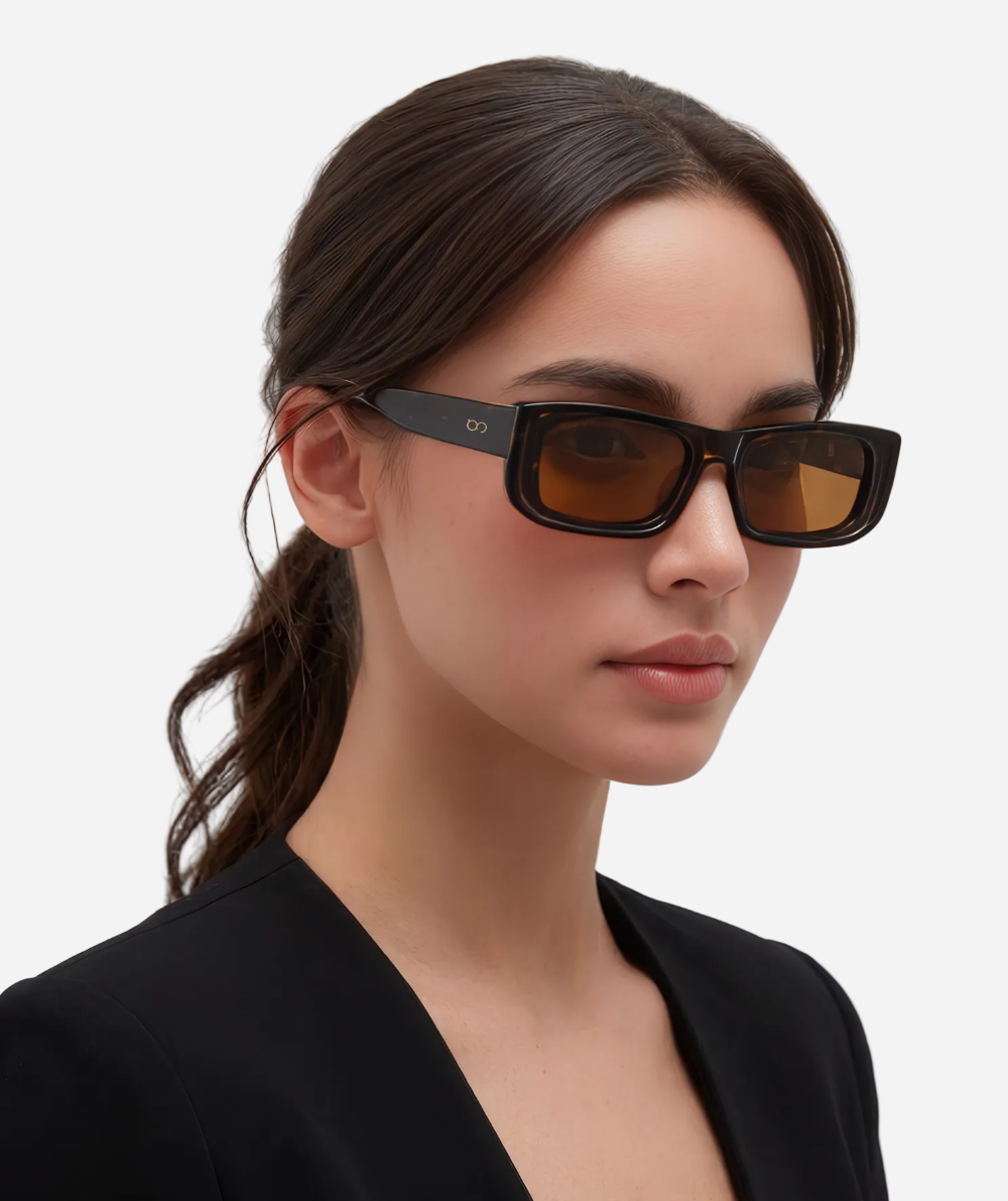 Woman wearing sunglasses with a plain background