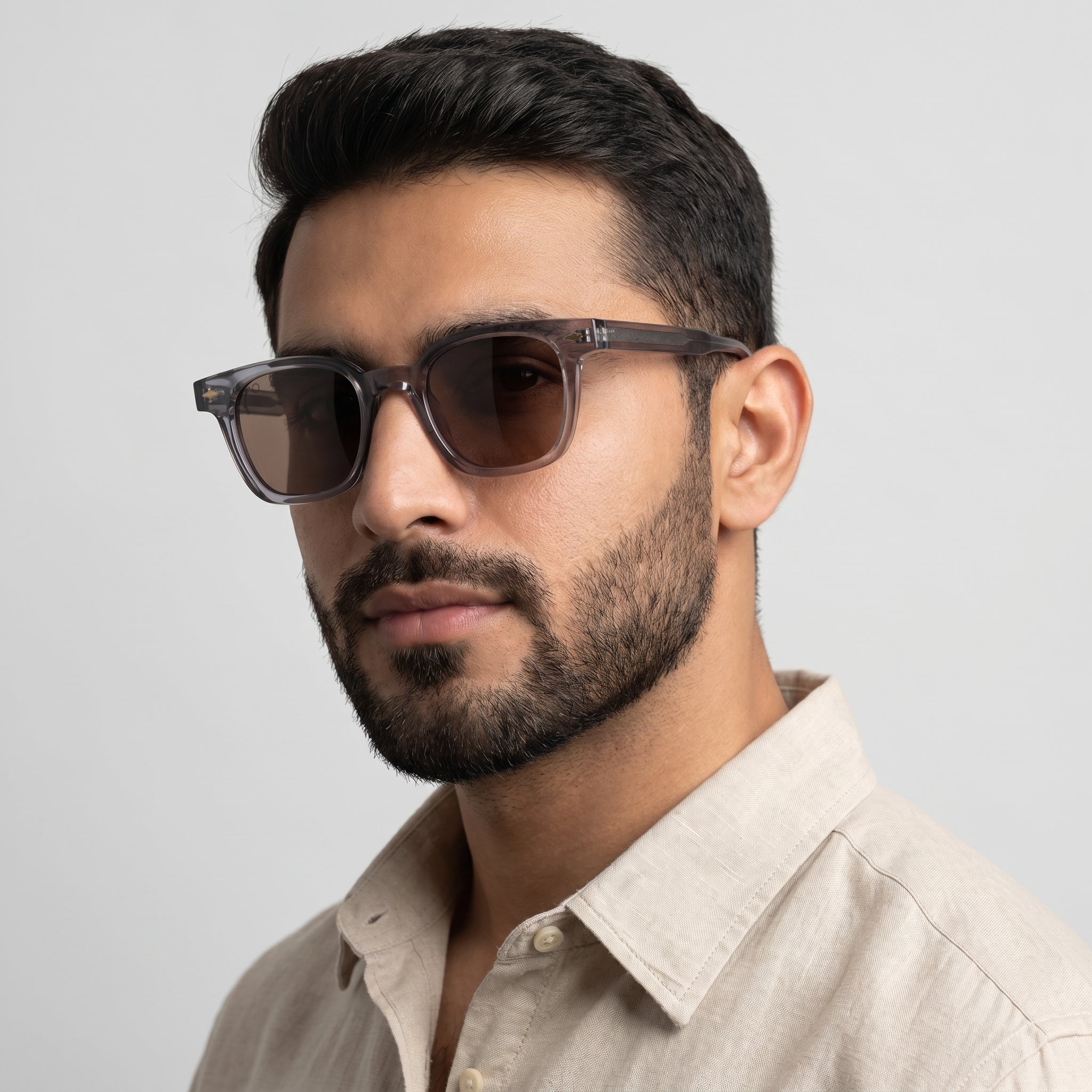 Man wearing sunglasses with a neutral background